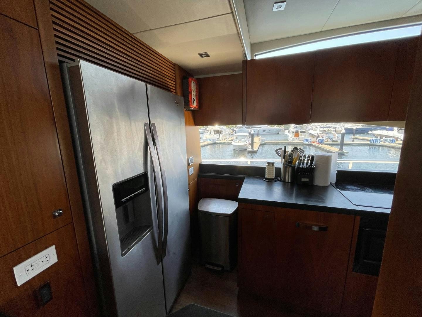 a kitchen with a stainless steel refrigerator aboard TRAINERA Yacht for Sale