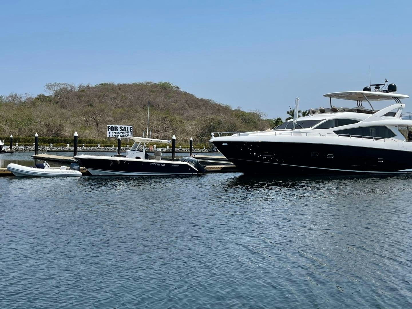 a couple of boats sit in a harbor aboard TRAINERA Yacht for Sale