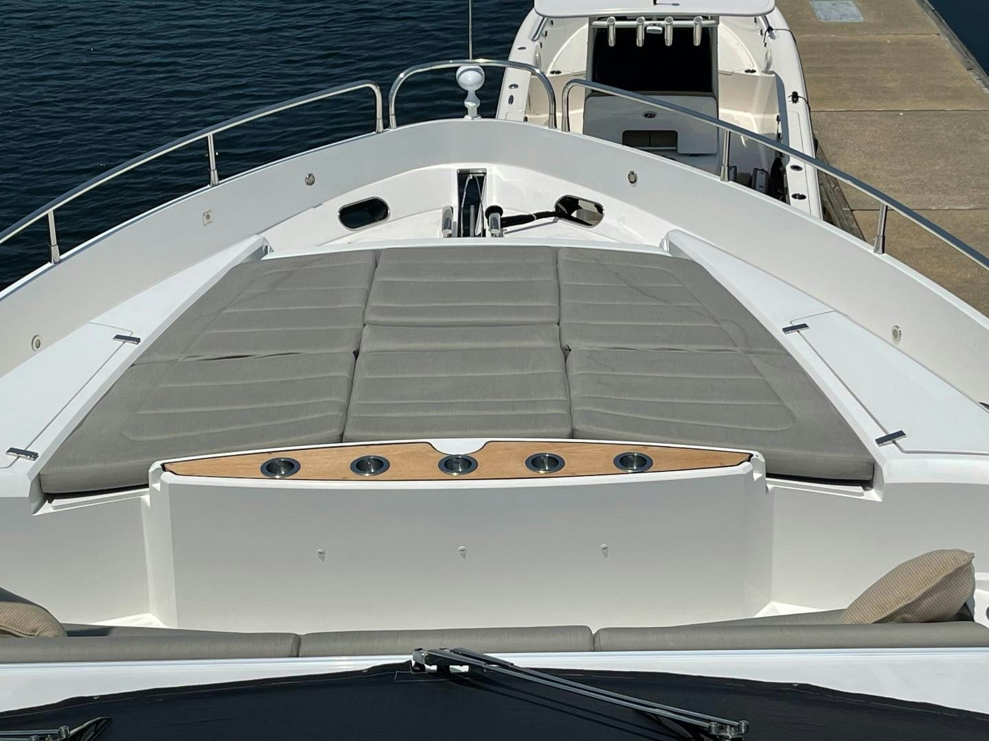 a white boat with a black and gold object on the front aboard TRAINERA Yacht for Sale