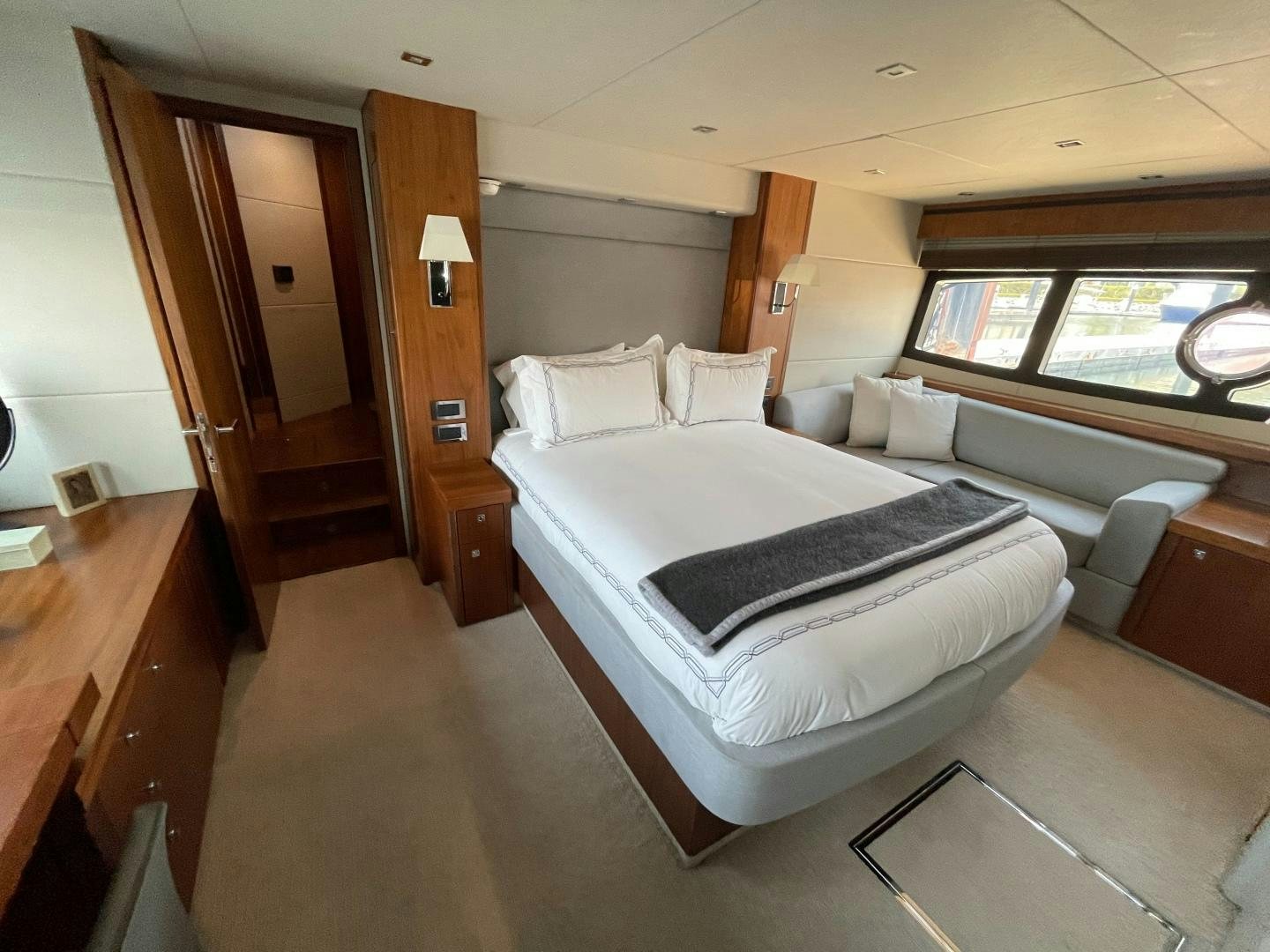 a room with a bed and a window aboard TRAINERA Yacht for Sale