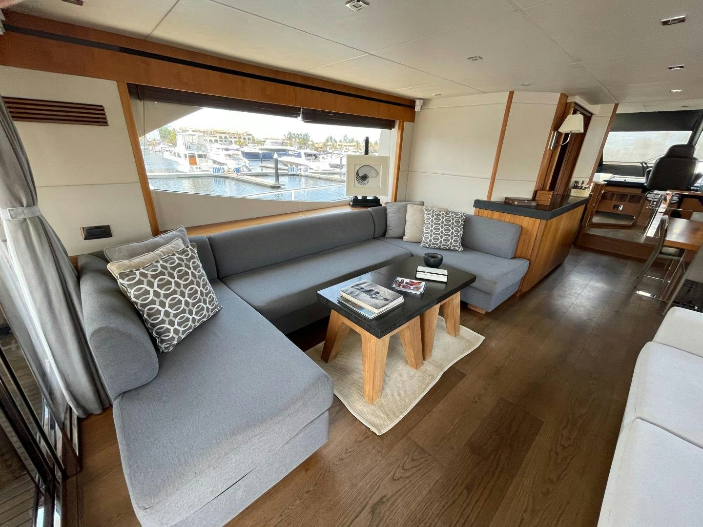 a living room with a large window aboard TRAINERA Yacht for Sale