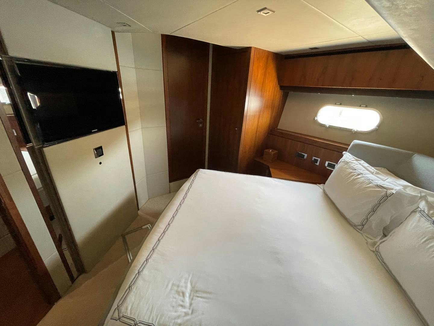 a bed with a television on it aboard TRAINERA Yacht for Sale