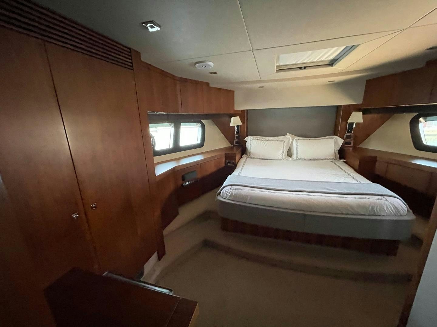 a room with a bed and a window aboard TRAINERA Yacht for Sale