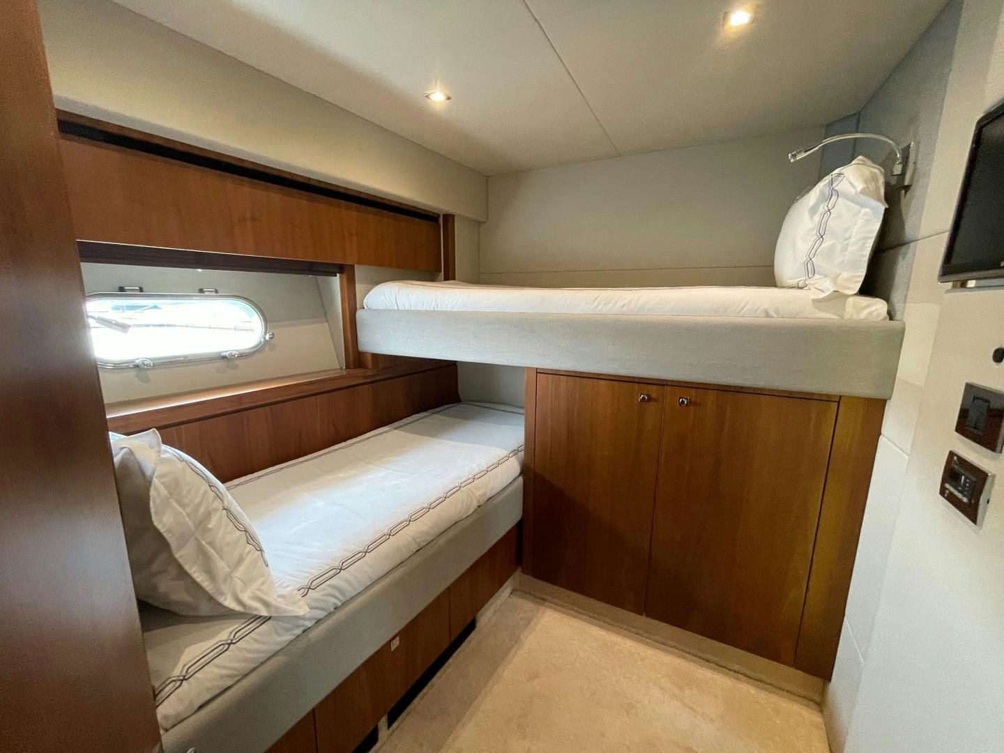 a room with a bed and a television aboard TRAINERA Yacht for Sale