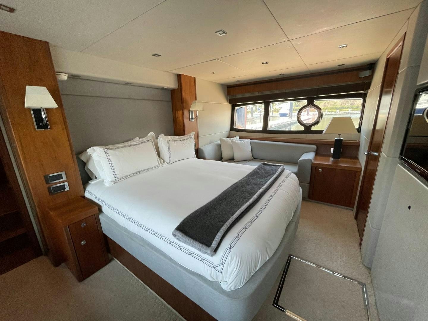 a bedroom with a bed and a desk aboard TRAINERA Yacht for Sale