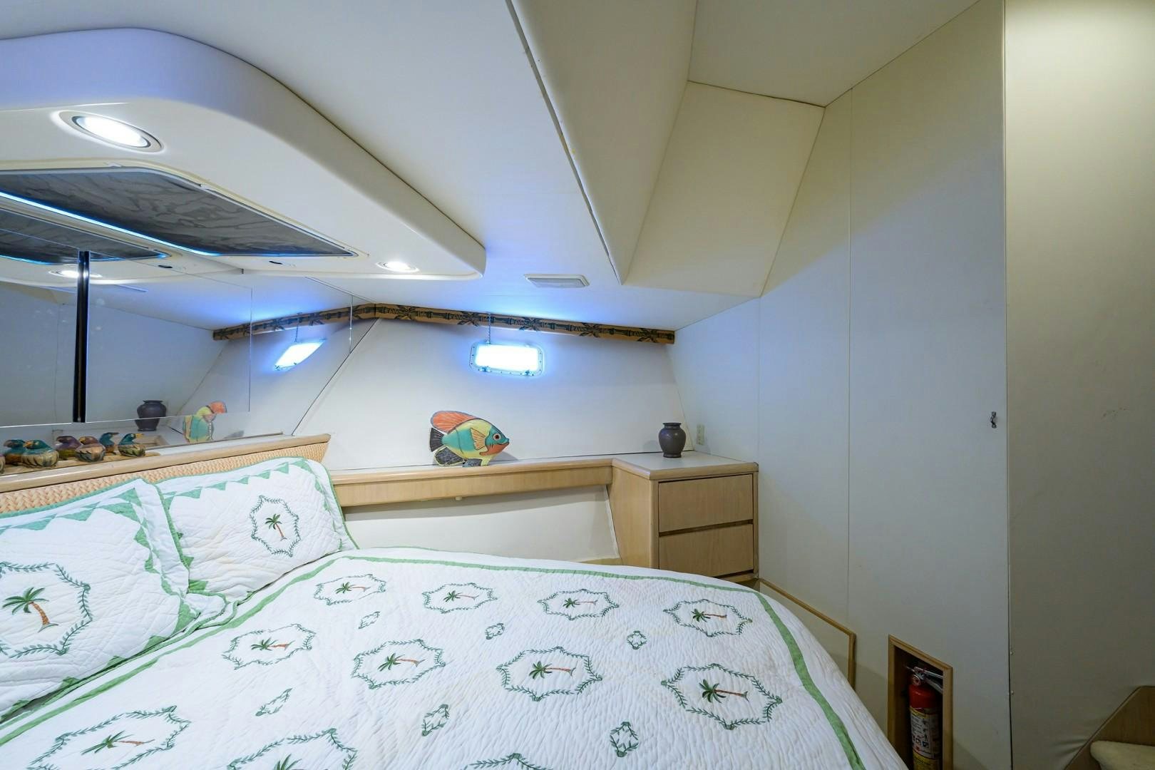 a bedroom with a bed and a ceiling fan aboard GYPSY ROSE Yacht for Sale