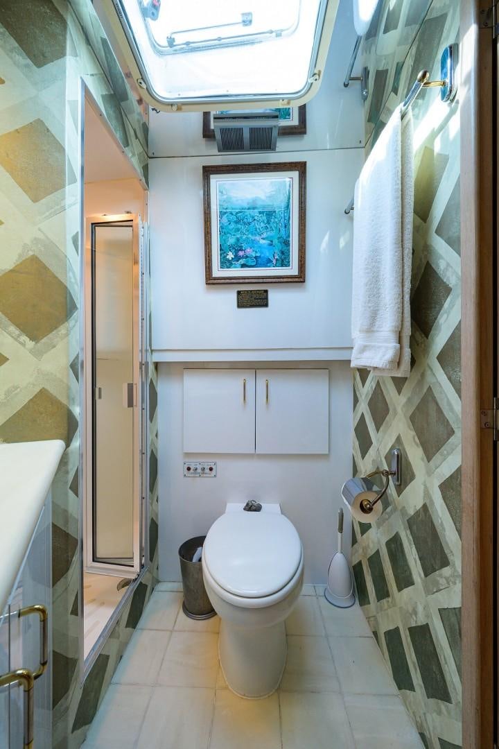 a bathroom with a toilet and a sink aboard GYPSY ROSE Yacht for Sale