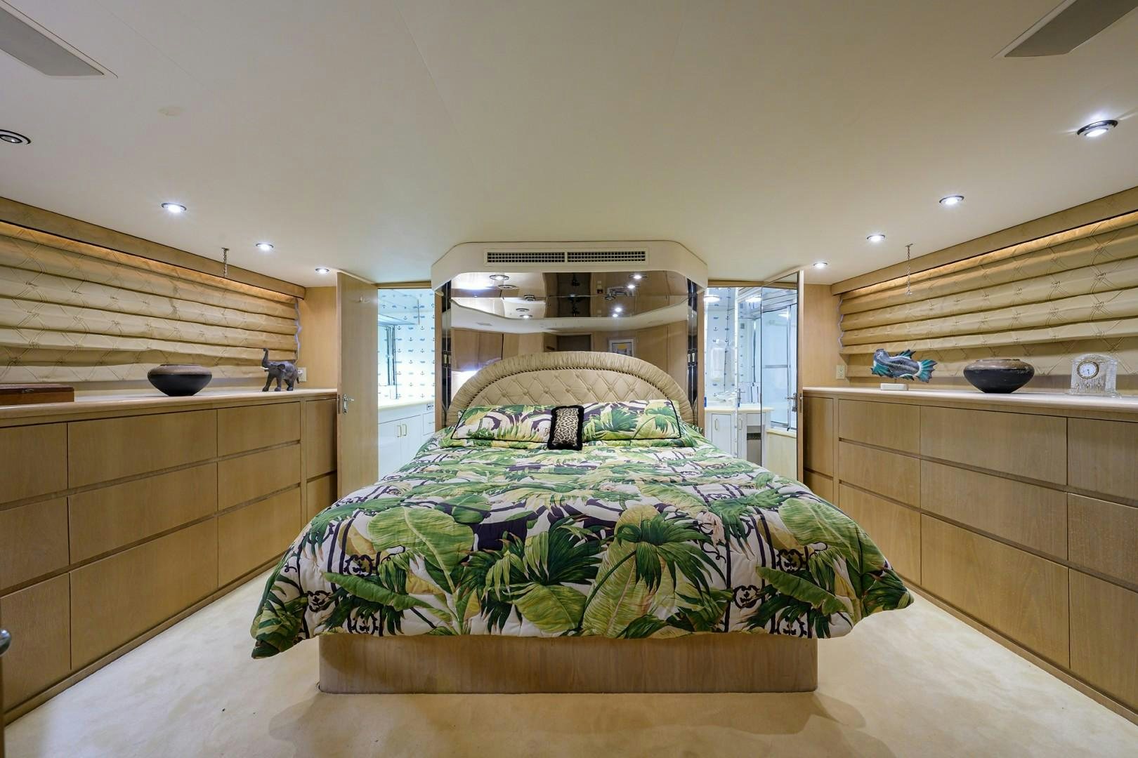 a bedroom with a bed and a dresser aboard GYPSY ROSE Yacht for Sale