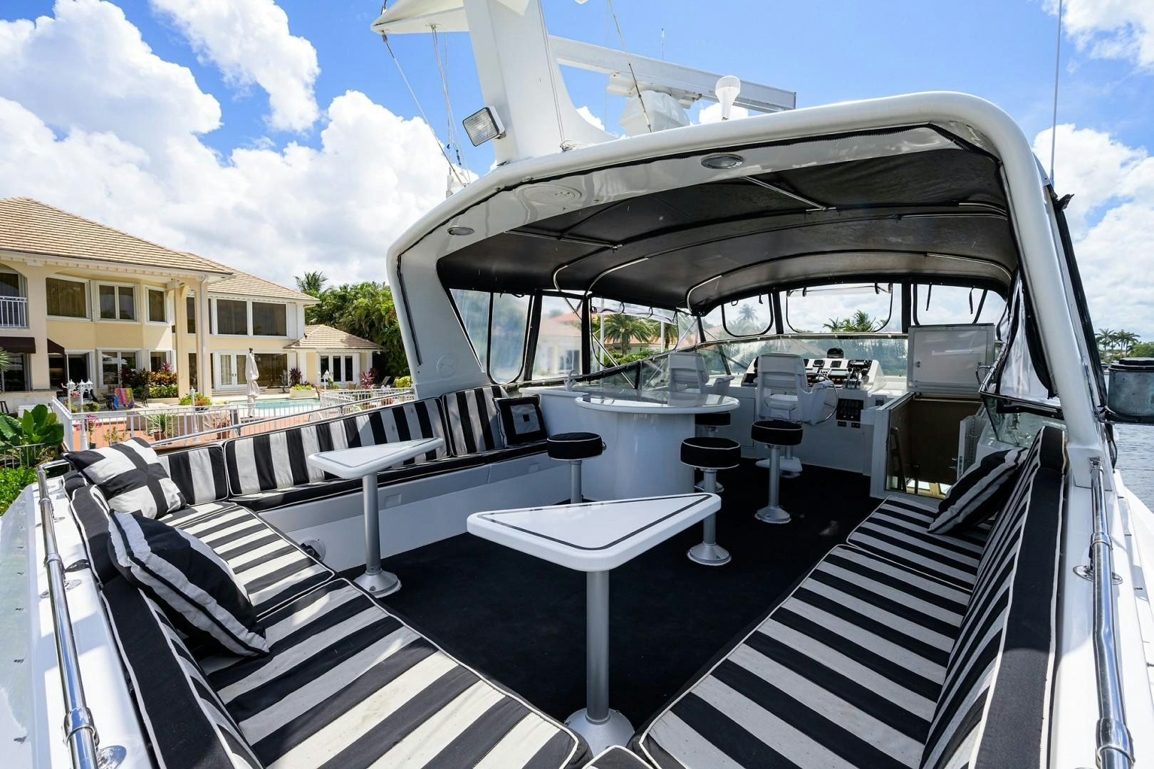 a boat with a black and white striped deck and a black and white striped roof aboard GYPSY ROSE Yacht for Sale