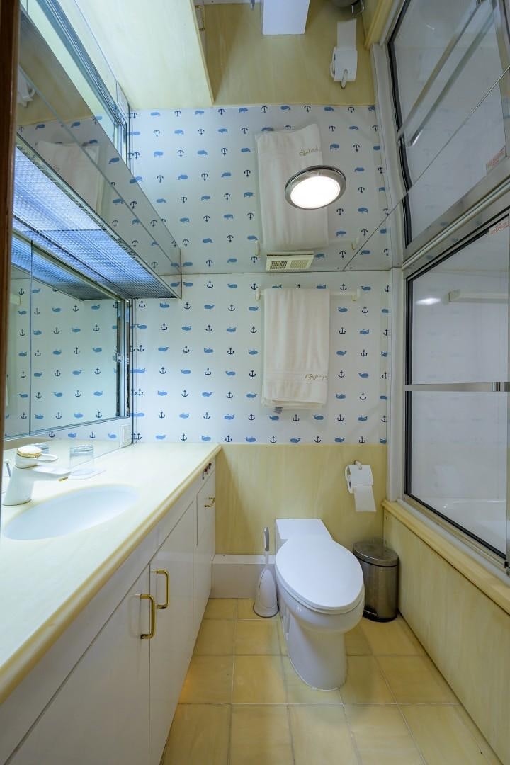 a bathroom with a toilet and sink aboard GYPSY ROSE Yacht for Sale