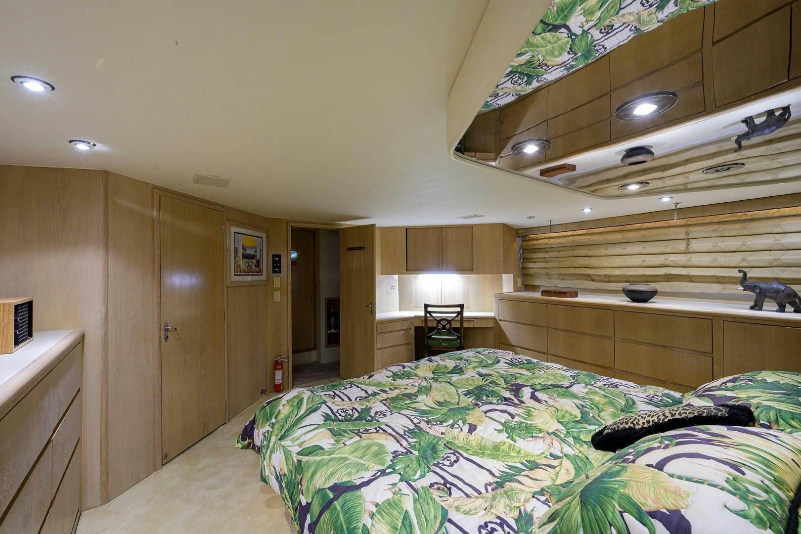 a bedroom with a bed and a desk aboard GYPSY ROSE Yacht for Sale