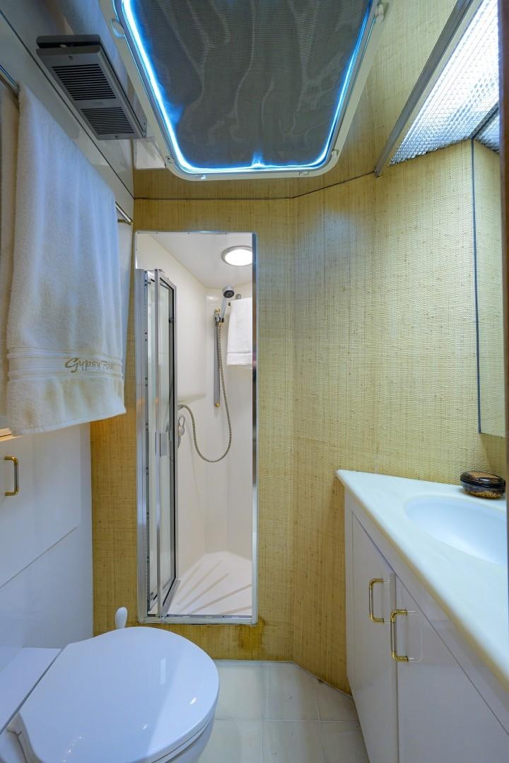 a bathroom with a shower and a toilet aboard GYPSY ROSE Yacht for Sale