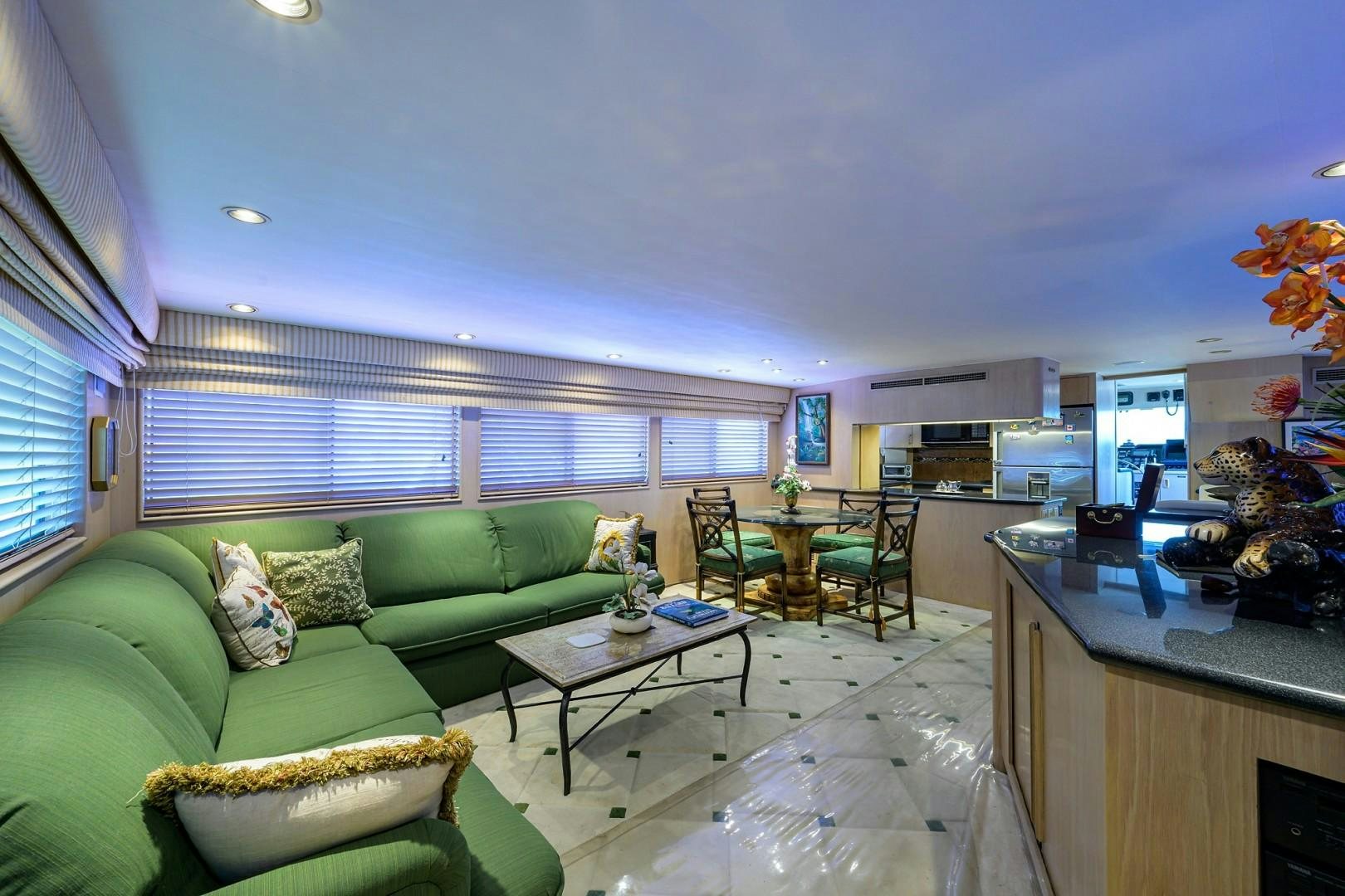 a living room with a green couch aboard GYPSY ROSE Yacht for Sale