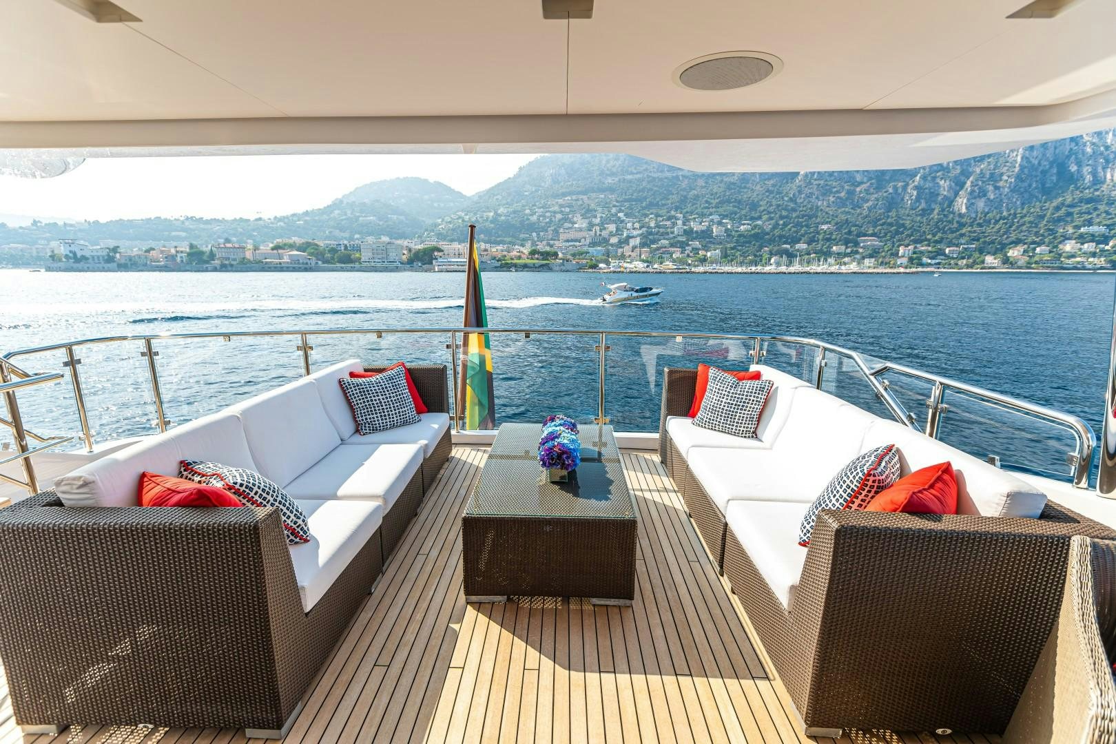 a deck with chairs and pillows on it by the ocean aboard DYLAN ANNE Yacht for Sale