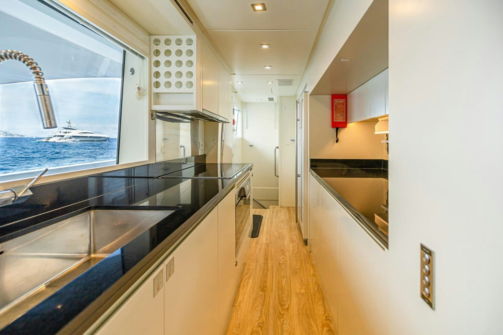 a kitchen with a large glass window aboard DYLAN ANNE Yacht for Sale