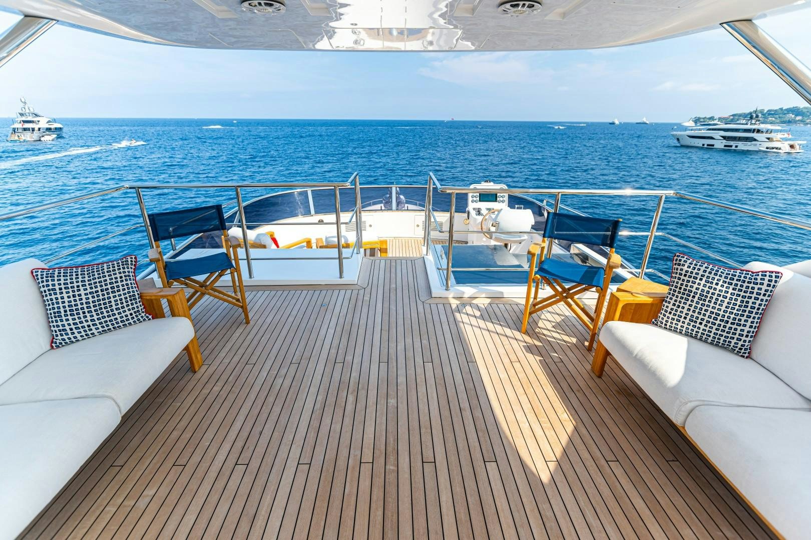 a deck with chairs and a body of water in the background aboard DYLAN ANNE Yacht for Sale