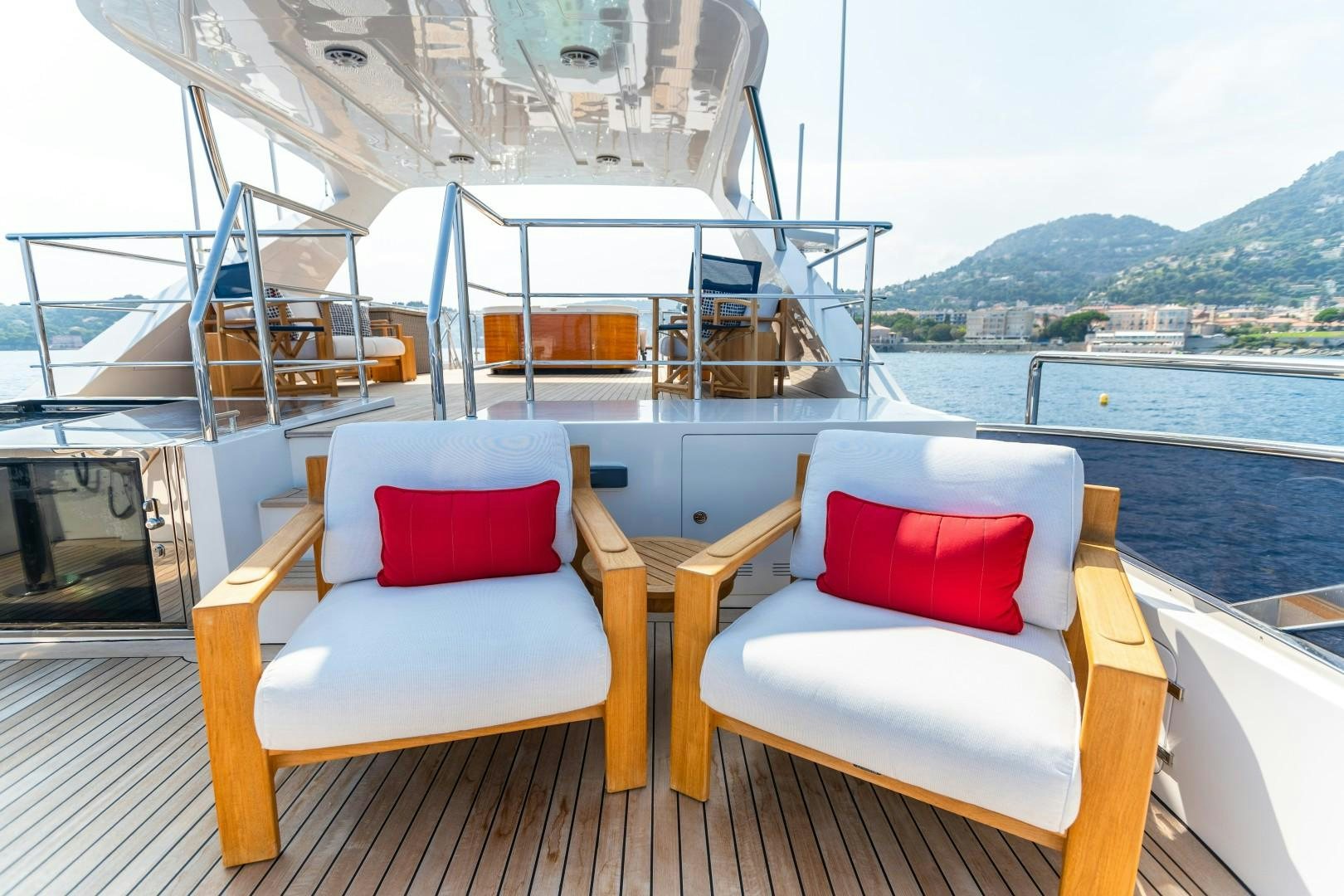 a couple of chairs on a deck overlooking a large body of water aboard DYLAN ANNE Yacht for Sale