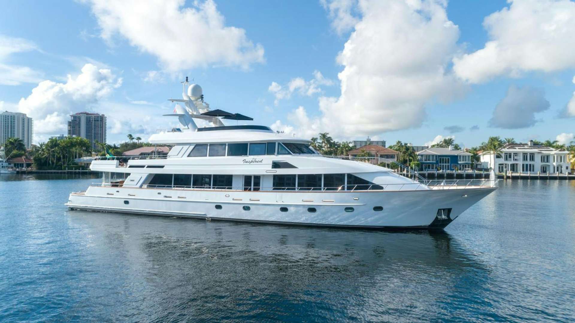 a white yacht in the water aboard INSPIRED Yacht for Sale