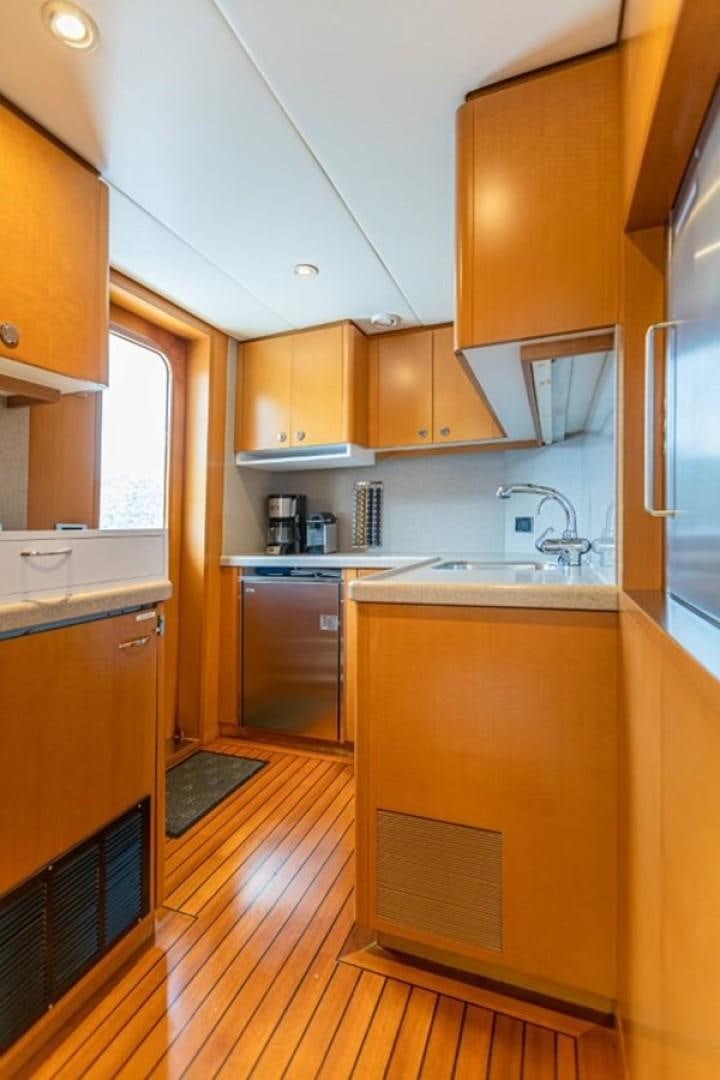 a kitchen with wooden cabinets aboard TASIA Yacht for Sale