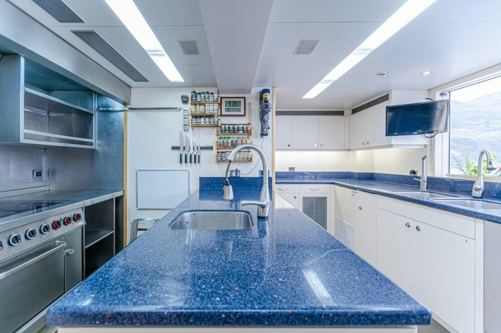 a kitchen with a blue counter top aboard TASIA Yacht for Sale