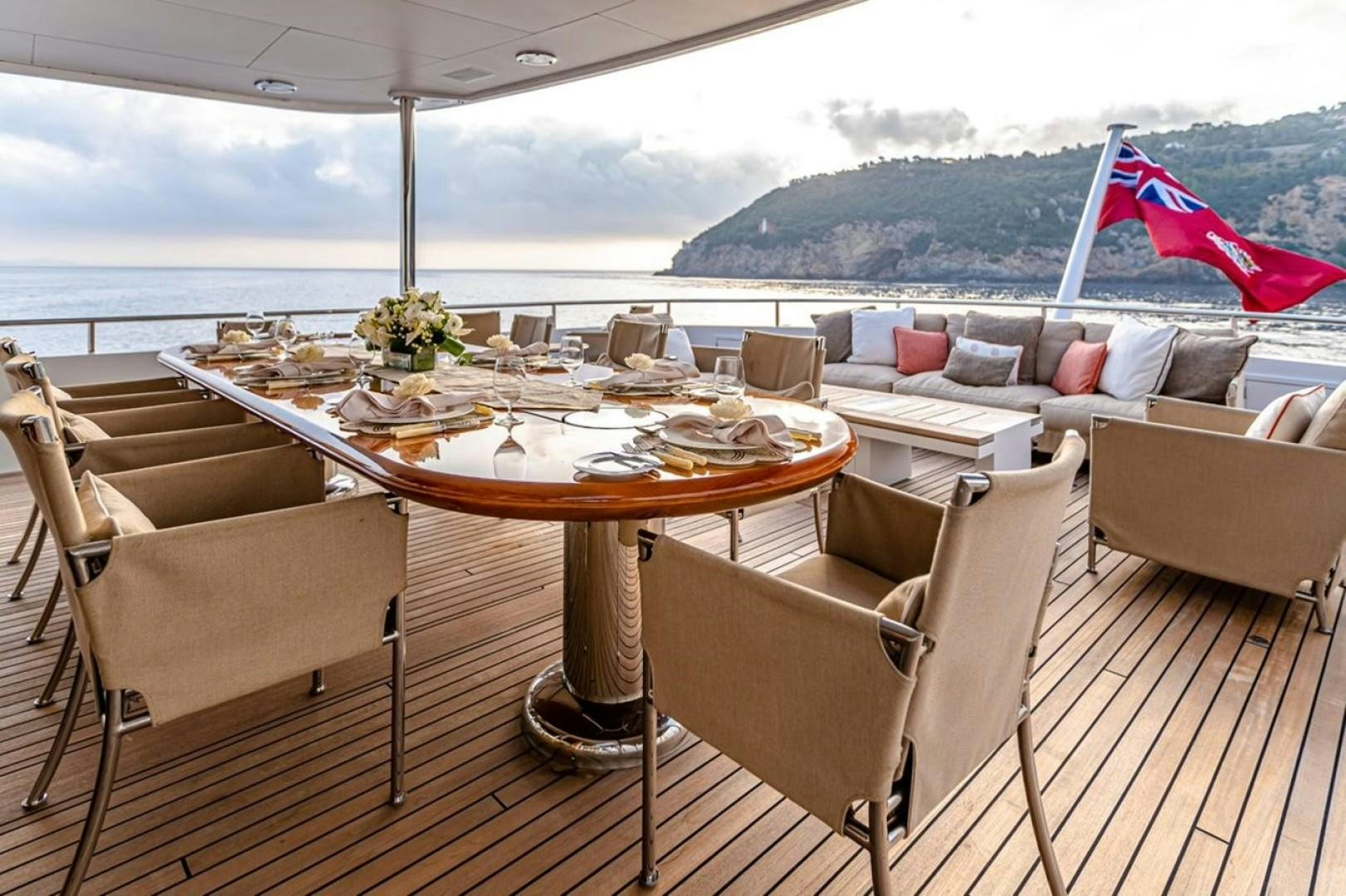 a table set for a meal on a deck aboard TASIA Yacht for Sale