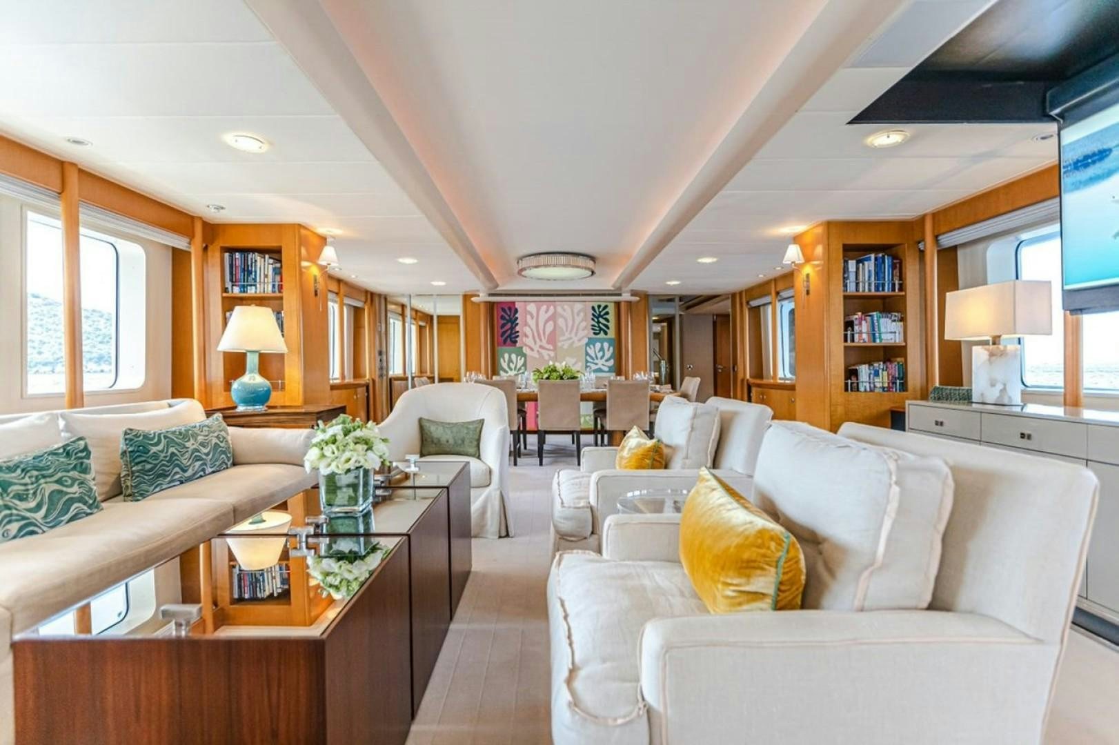 a living room with a couch and a coffee table aboard TASIA Yacht for Sale