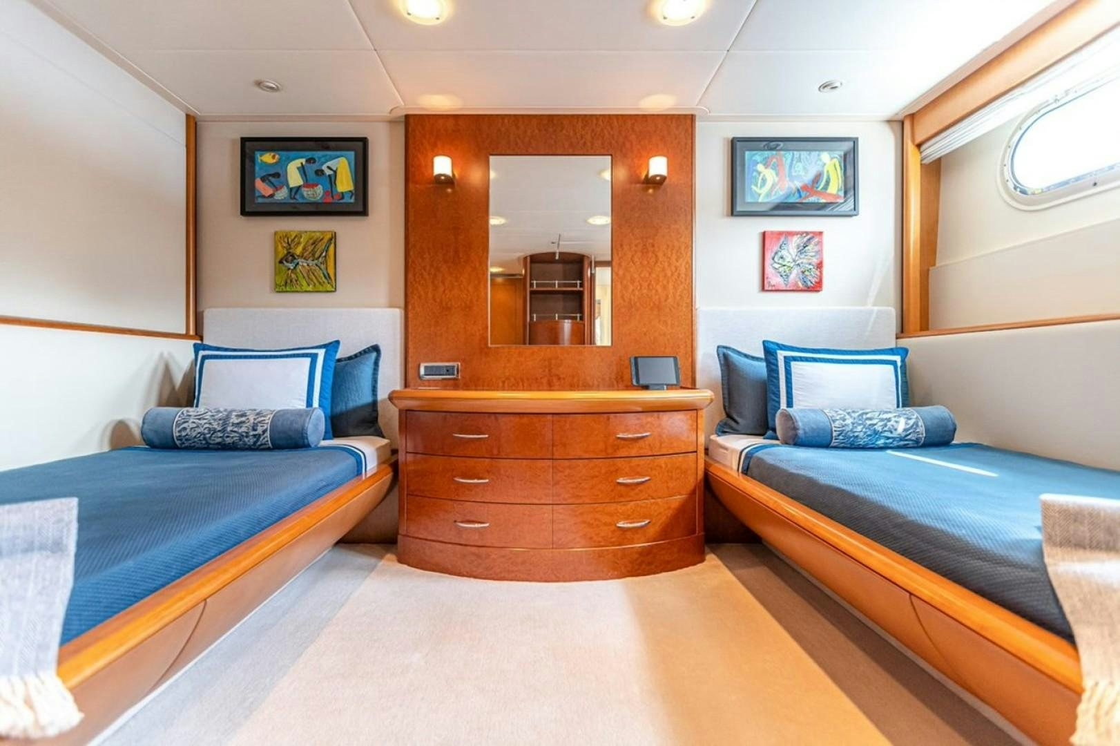 a room with a bed and a mirror aboard TASIA Yacht for Sale