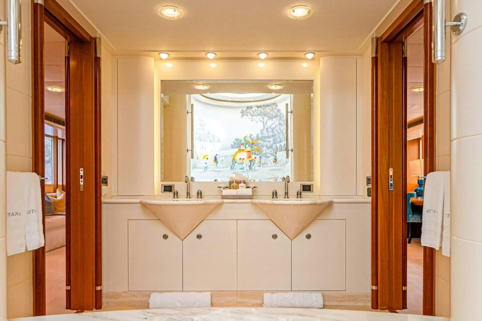 a bathroom with a large mirror aboard TASIA Yacht for Sale
