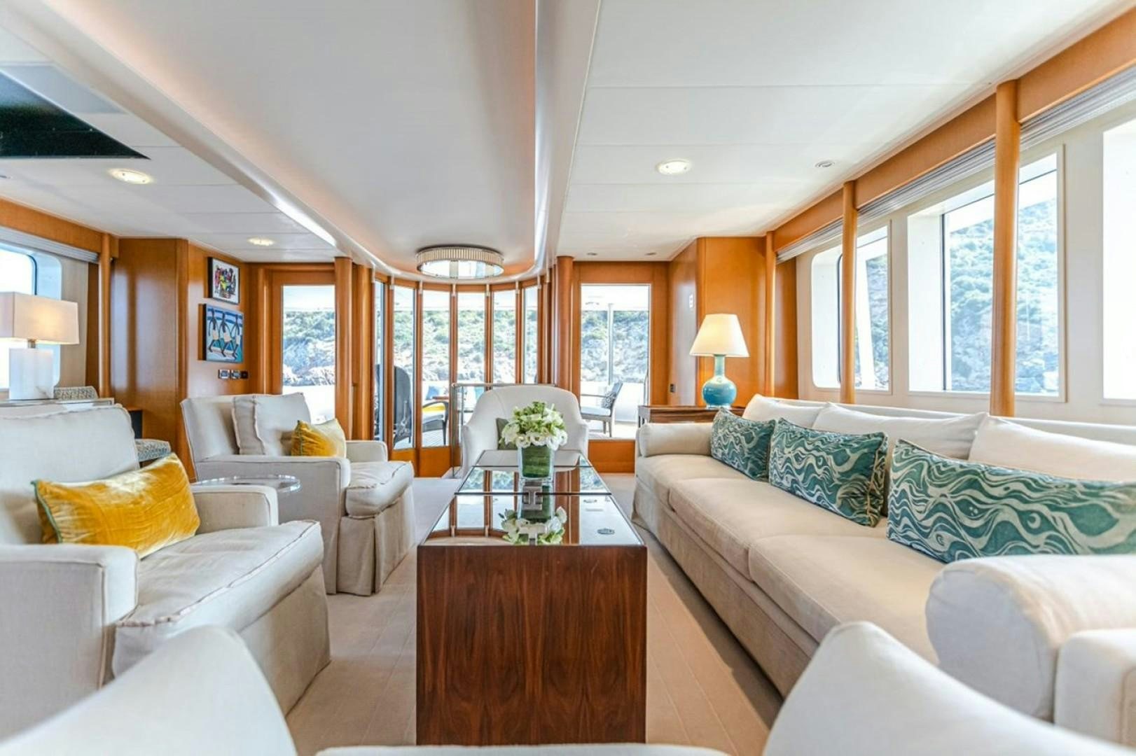 a living room with a couch and a coffee table aboard TASIA Yacht for Sale