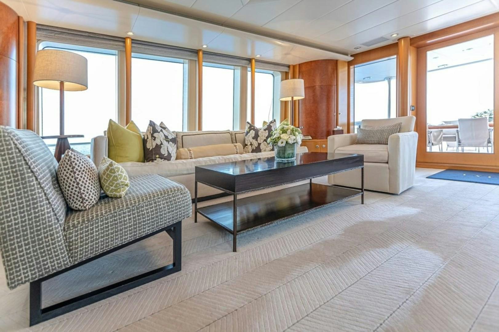 a living room with a couch and a coffee table aboard TASIA Yacht for Sale