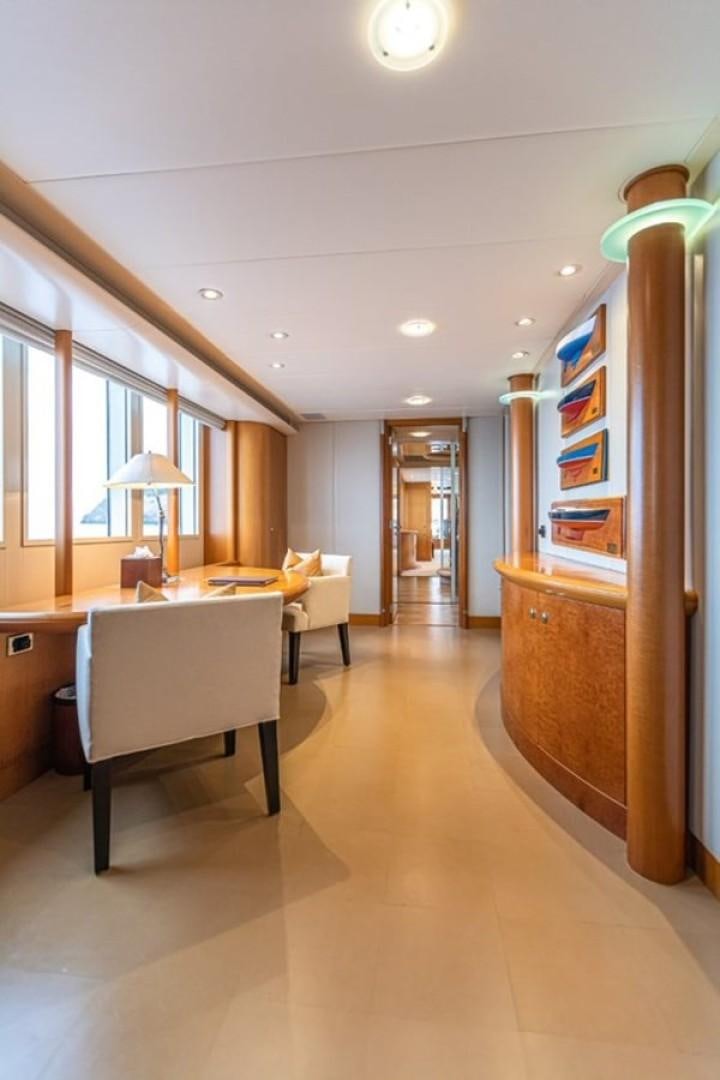 a room with a table and chairs aboard TASIA Yacht for Sale