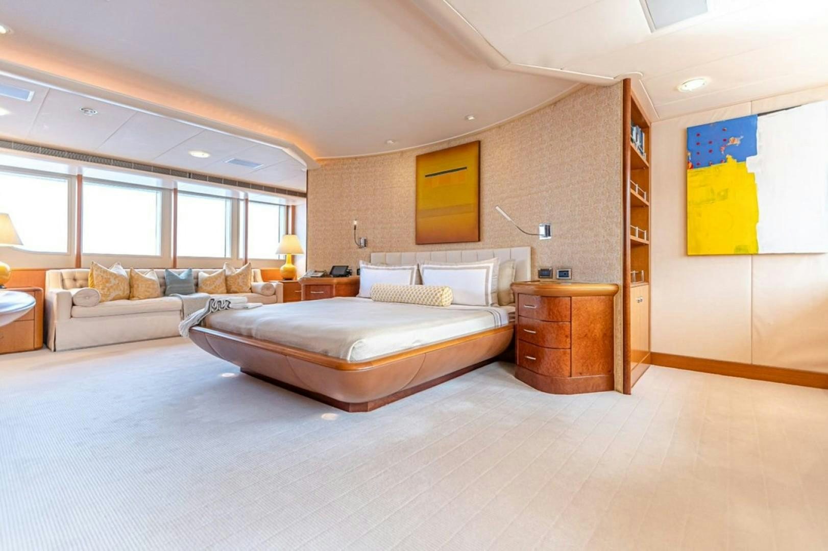 a bedroom with a bed and a desk aboard TASIA Yacht for Sale