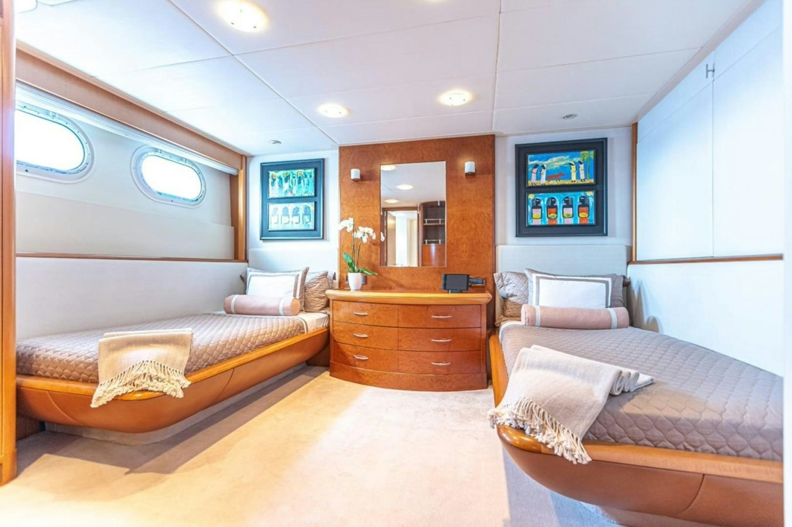 a bedroom with a bed and a dresser aboard TASIA Yacht for Sale