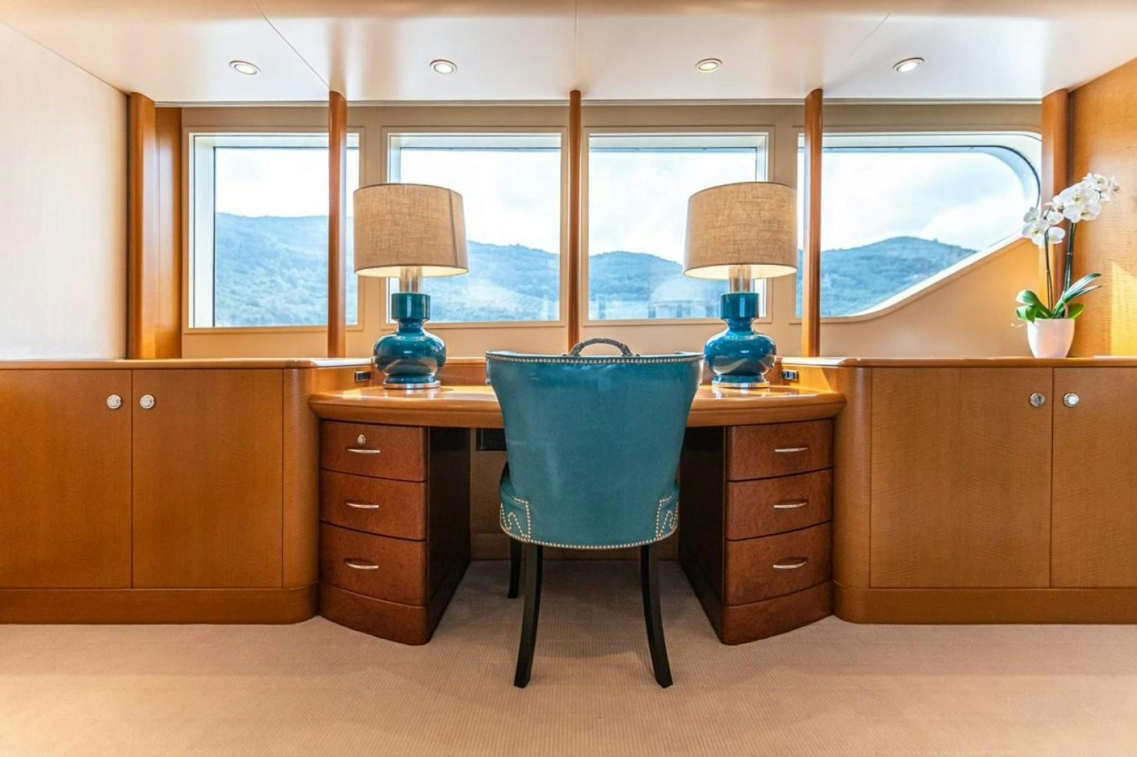 a room with a desk and a lamp aboard TASIA Yacht for Sale