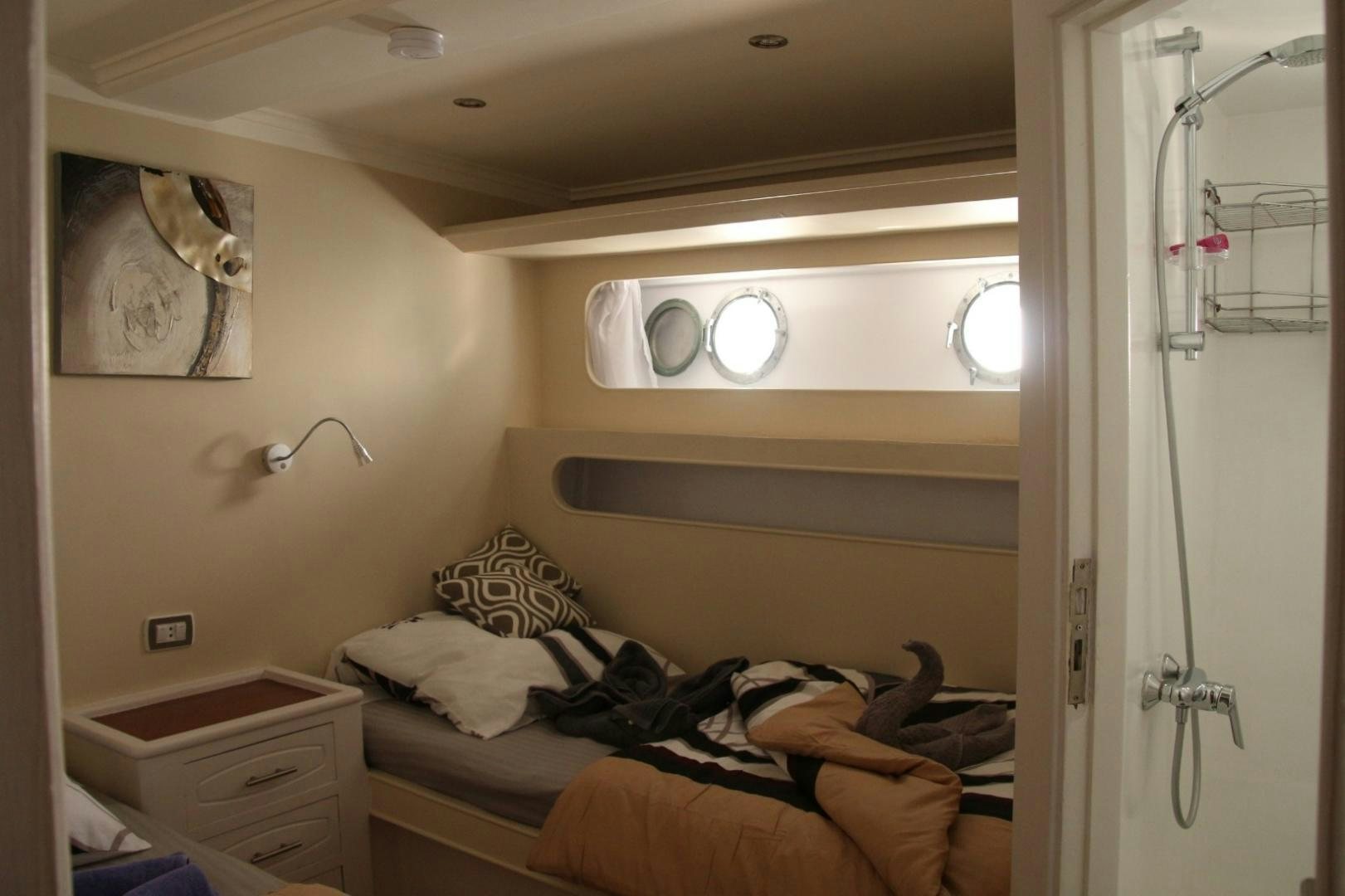 a room with a bed and a mirror aboard SIM SIM Yacht for Sale