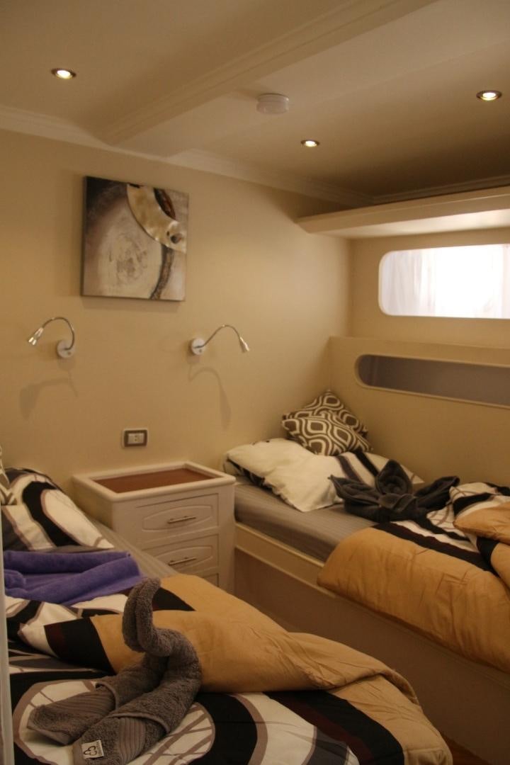 a room with a couple of beds aboard SIM SIM Yacht for Sale