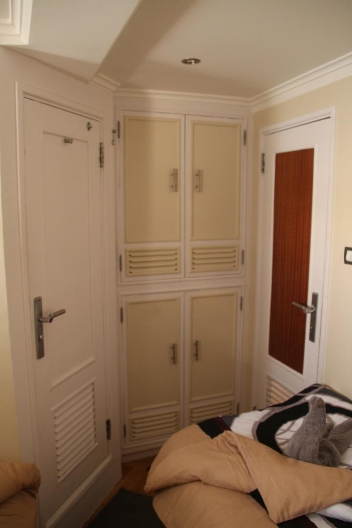 a white door with a person lying on it aboard SIM SIM Yacht for Sale