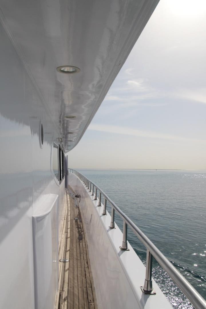 a long white boat on the water aboard SIM SIM Yacht for Sale