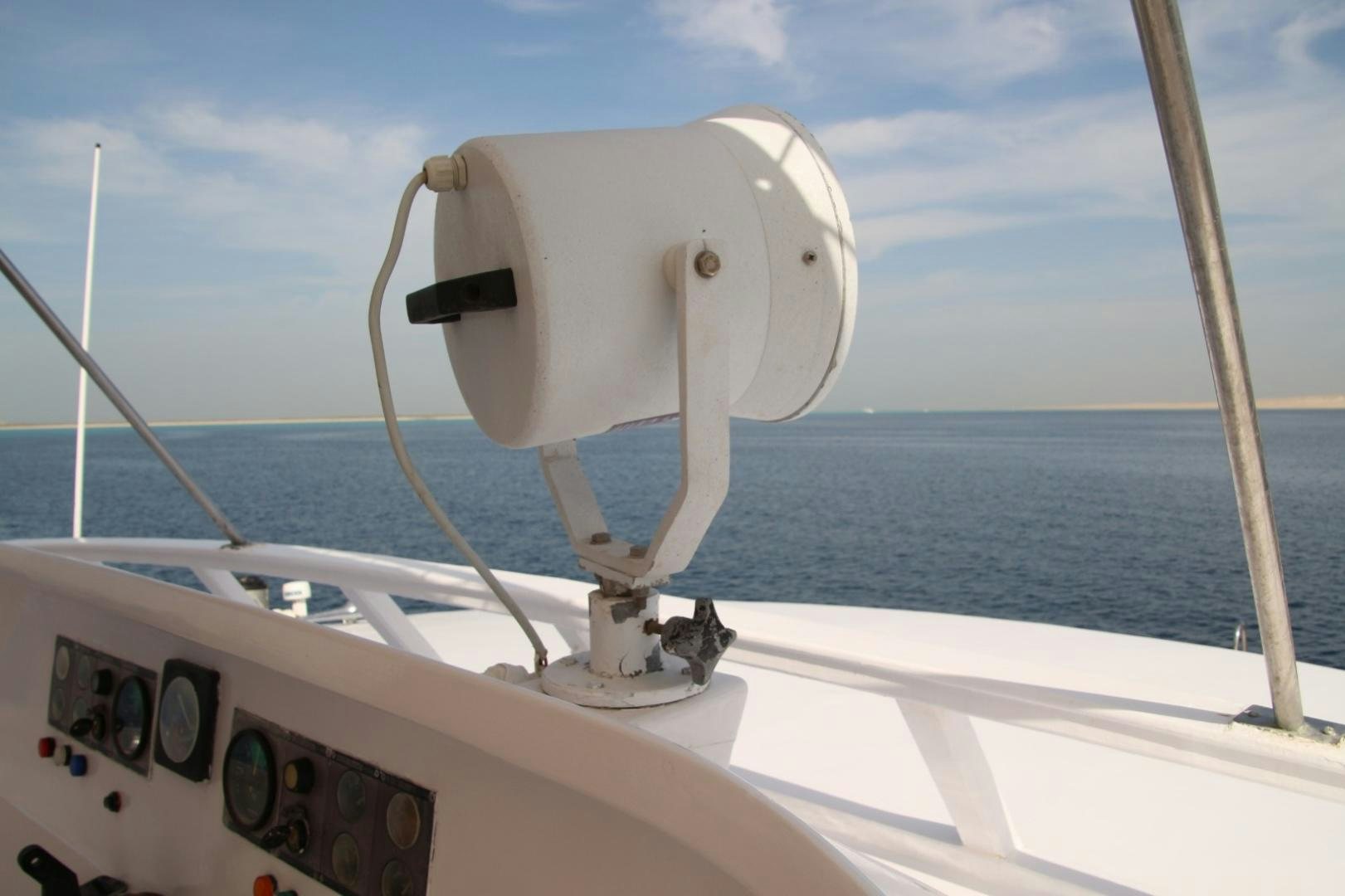 a white boat with a steering wheel aboard SIM SIM Yacht for Sale