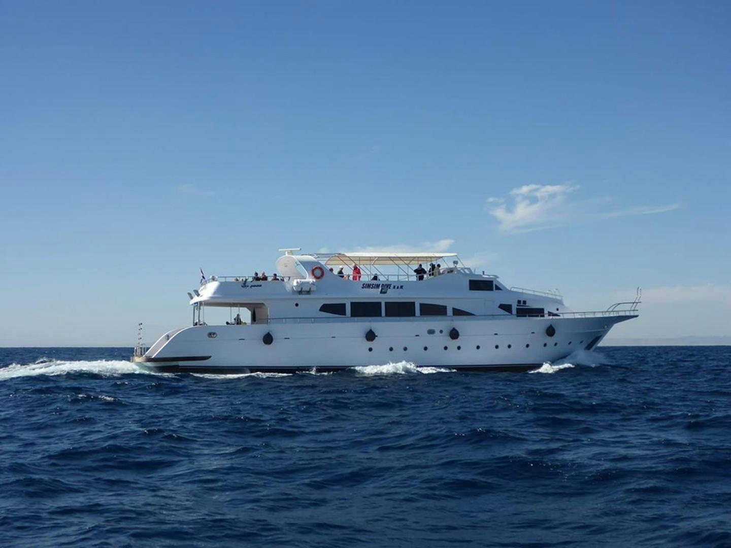 a white boat on the water aboard SIM SIM Yacht for Sale