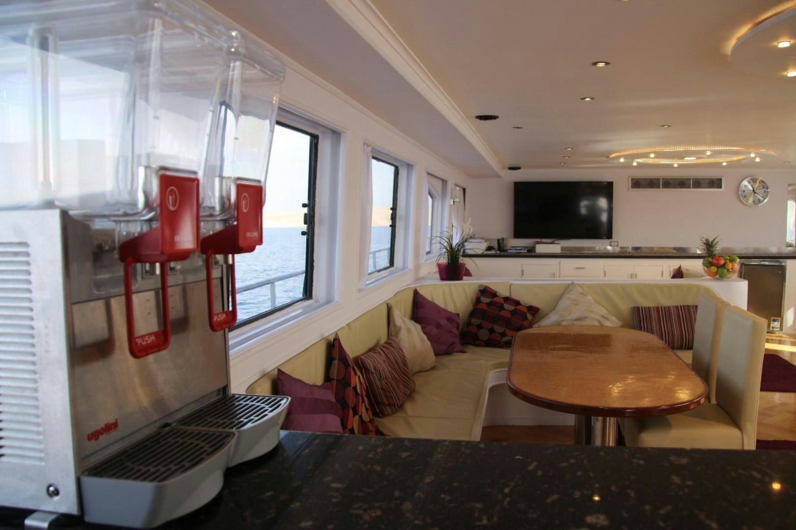 a living room with a couch and a tv aboard SIM SIM Yacht for Sale