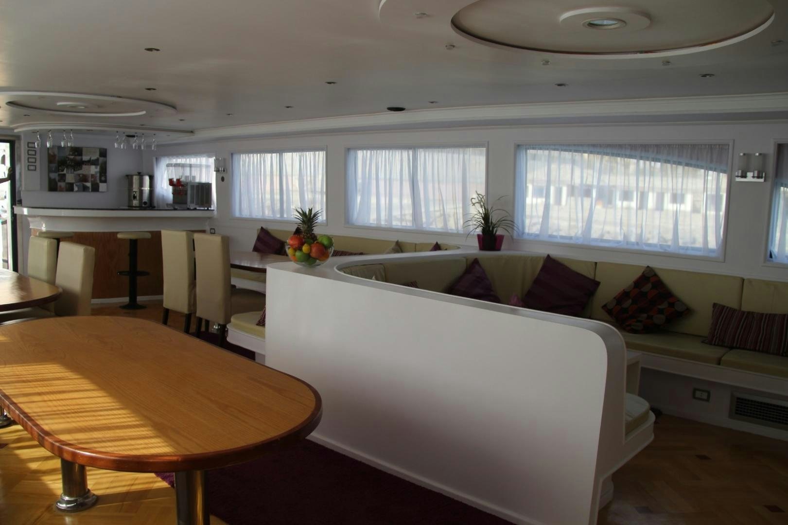 a living room with a couch and a table aboard SIM SIM Yacht for Sale