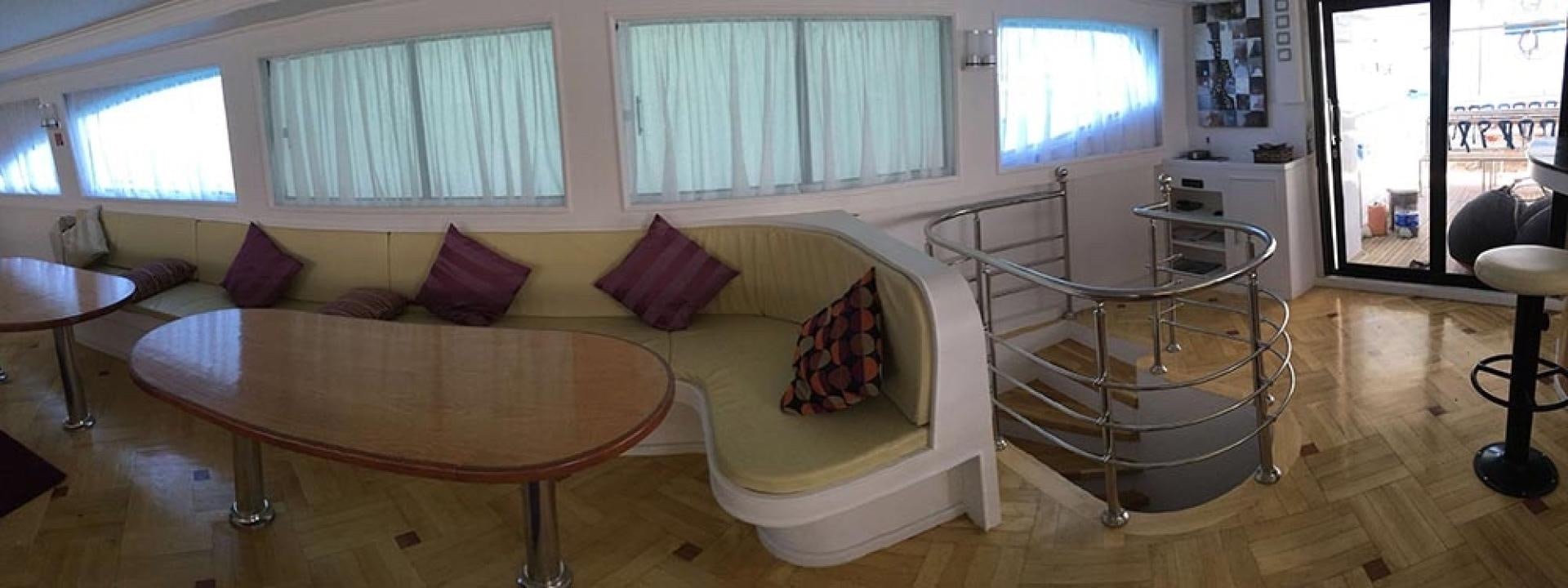 a living room with a table and chairs aboard SIM SIM Yacht for Sale