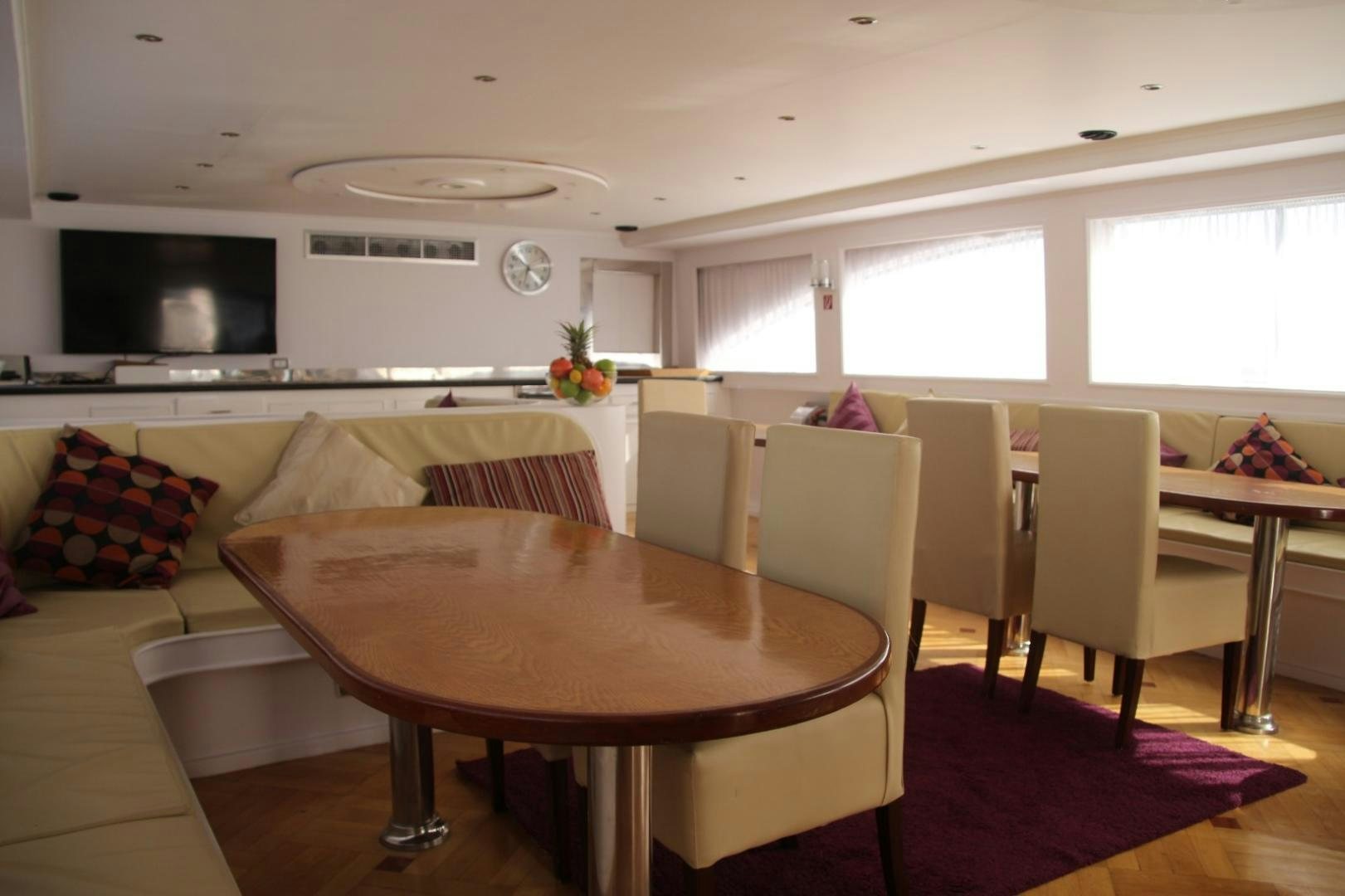 a living room with a table and chairs aboard SIM SIM Yacht for Sale