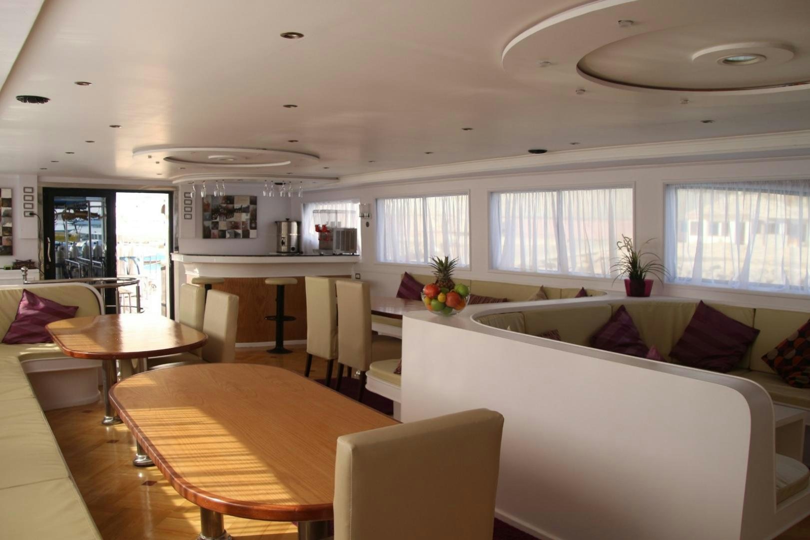 a living room with a table and chairs aboard SIM SIM Yacht for Sale
