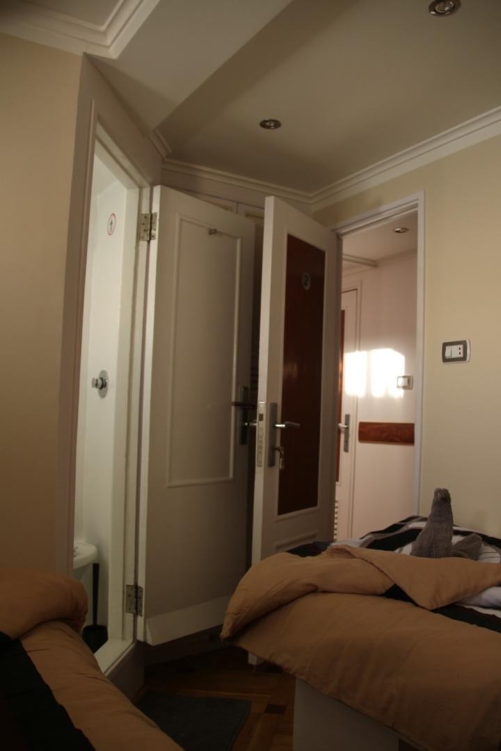 a room with a bed and a door aboard SIM SIM Yacht for Sale