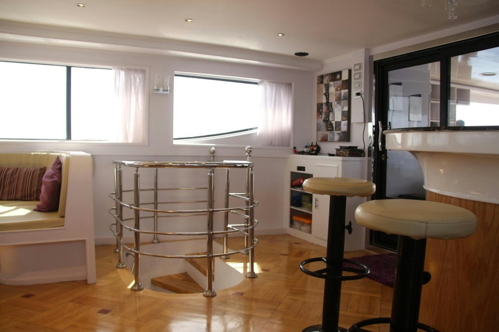 a room with a bunk bed and stools aboard SIM SIM Yacht for Sale