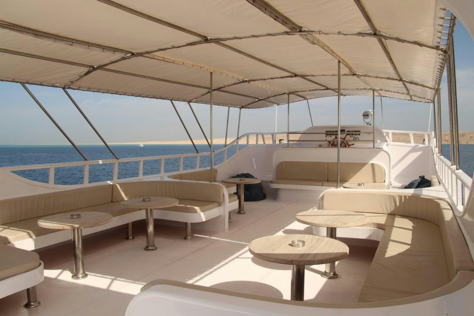 a room with a view of the pool and the deck aboard SIM SIM Yacht for Sale