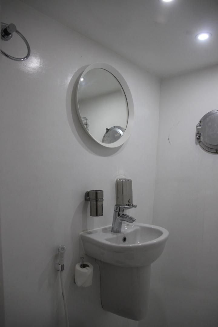a bathroom with a sink and mirror aboard SIM SIM Yacht for Sale