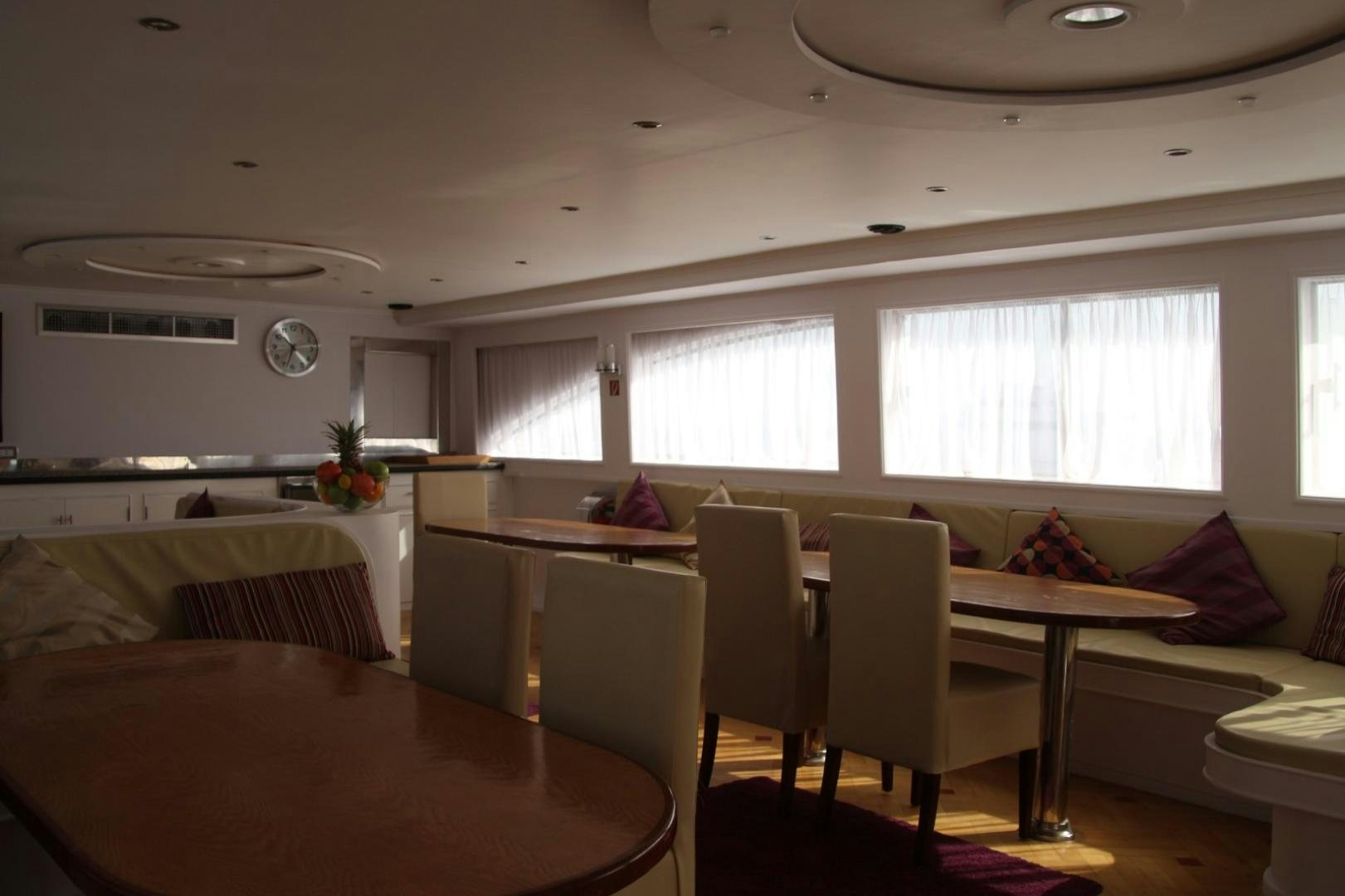 a room with a table and chairs aboard SIM SIM Yacht for Sale